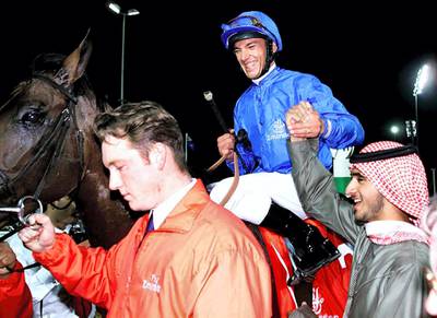 Dubai Millennium ridden by Frankie Dettori, raises the hand of sheikh Rashed the son of Sheikh Mohammed Bin Rashed Al-Maktoum, UAE Minister of Defence and Crown Prince of Dubai, after winning Dubai's richest horse race 25 March 2000.   (ELECTRONIC IMAGE) (Photo by RABIH MOGHRABI / AFP)