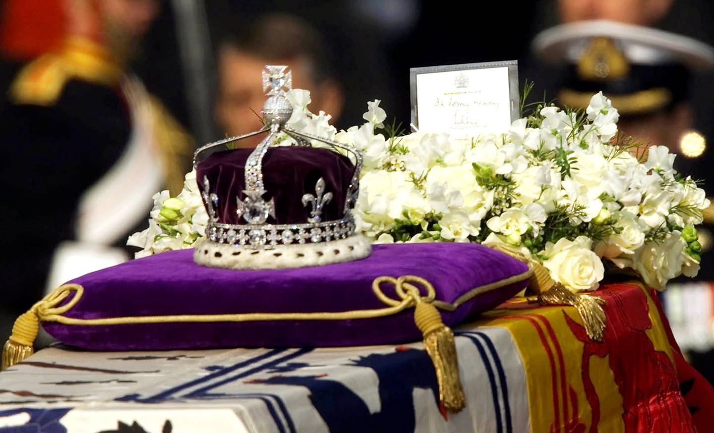 The Koh-i-Noor, or "mountain of light", diamond, set in the Maltese Cross at the front of the crown made for Britain's Queen Mother, is seen on her coffin, as it is drawn to London's Westminster Hall on April 5, 2002. AP