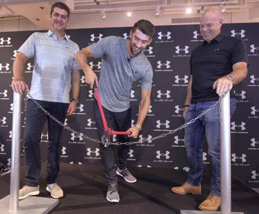 Swimming champion Michael Phelps cuts the chain at the grand opening of the Under Armour store at Dubai Mall. Under Armour