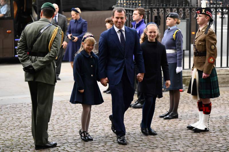 Peter Phillips, the queen's first grandson, arrives with his daughters Savannah and Isla. AFP