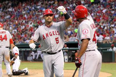 Angels star Albert Pujols is congratulated by Howard Kendrick after hitting his second homer of the game against Texas Rangers