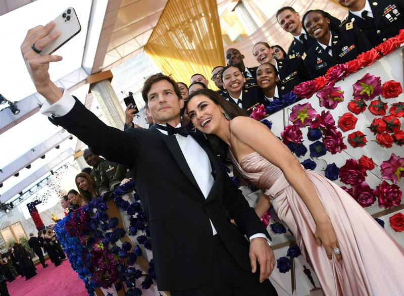 US actors Ashton Kutcher and Mila Kunis take a selfie at the 94th Oscars in Hollywood, California. AFP