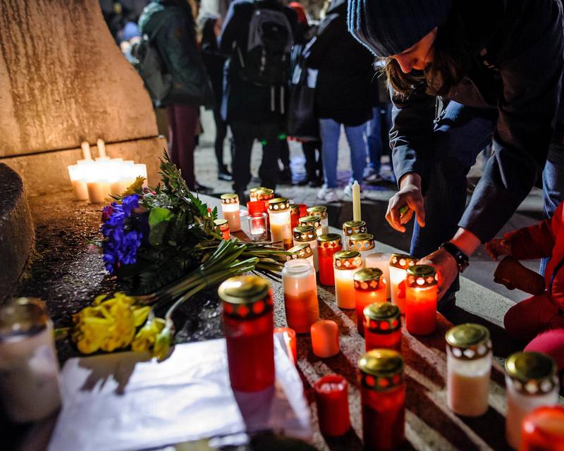 epa08232126 Mourners place candles and flowers at the Unity Memorial as people attend a vigil after the Hanau terror attack at the St. Paul's Church in Frankfurt am Main, Germany, 20 February 2020. According to the police, the alleged perpetrator of a terror attack in Hanau was found dead with a second dead person in his apartment. The number of victims killed at two crime scenes in the late night of 19 February increased to nine, so that the police speak of a total of eleven deaths.  EPA/MAXIMILIAN VON LACHNER