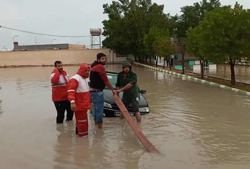 Iranian Red Crescent members help to tow a vehicle in Hormozgan. AFP
