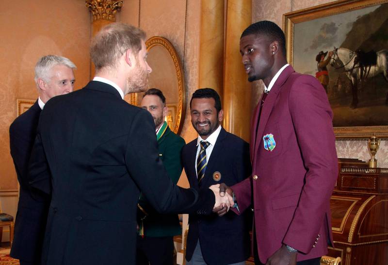 Britain's Prince Harry meets  West Indies cricket captain Jason Holder, right, South Africa cricket captain Francois du Plessis, left, and and Sri Lanka captain Dimuth Karunaratne during a Royal Garden Party at Buckingham Palace in London, Wednesday, May 29, 2019. (Yui Mok/Pool photo via AP)