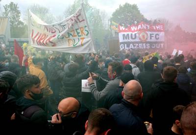 Fans hold up banners as they protest against the Glazer family at Old Trafford. PA