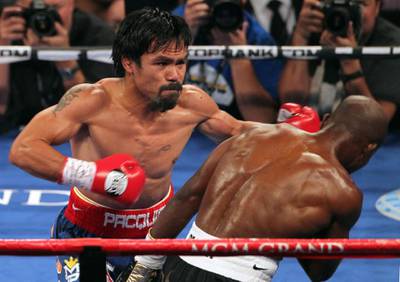 LAS VEGAS, NV - JUNE 09:  (L-R) Manny Pacquiao lands a left to the head of Timothy Bradley during their WBO welterweight title fight at MGM Grand Garden Arena on June 9, 2012 in Las Vegas, Nevada.  (Photo by Jeff Bottari/Getty Images)