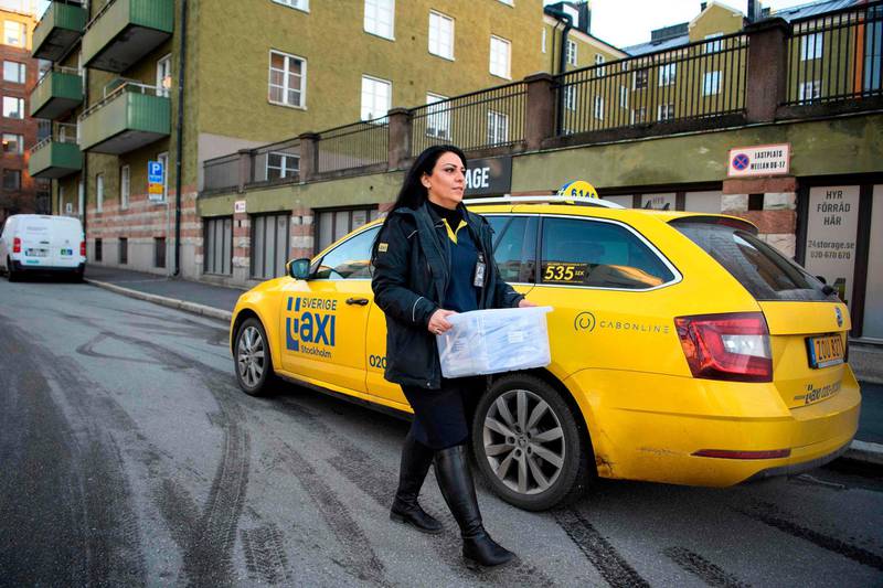 Taxi driver Nilofar Pegah collects covid tests in Solna. She delivers self tests to between 20 to 30 homes every day.  AFP