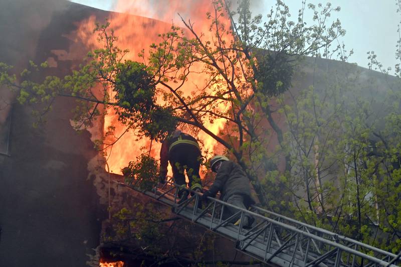 Firefighters tackle a blaze in a residential building, after a bombardment in central Kharkiv. AFP