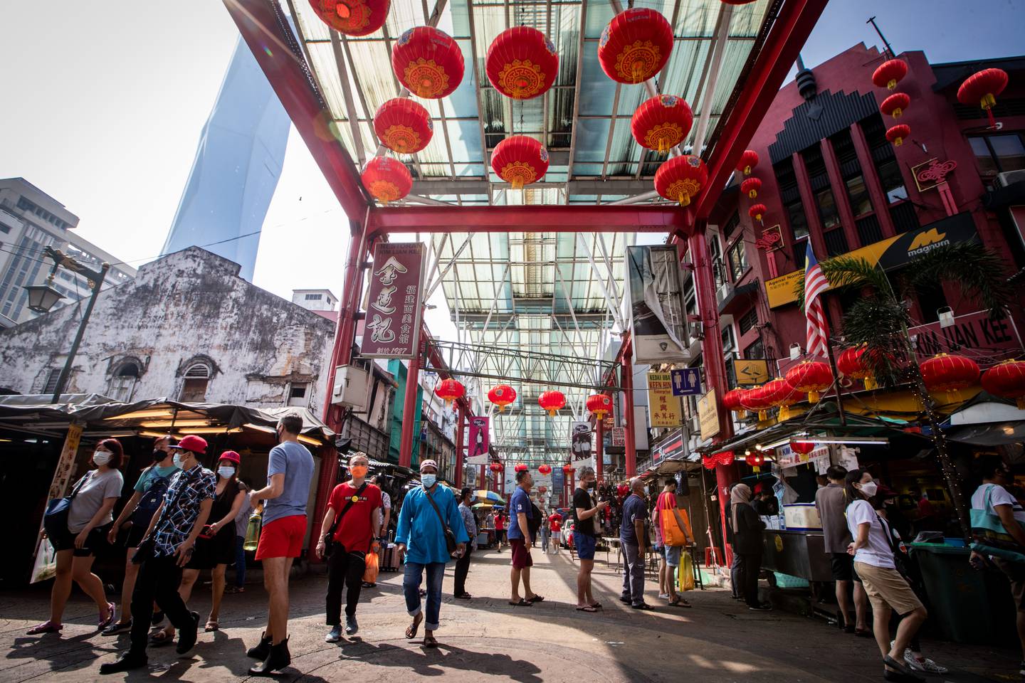 Shoppers walk under the Lunar New Year red lanterns  in the Chinatown district in Kuala Lumpur, Malaysia on January 30, 2022. Chinese Lunar New Year which falls on February 1, and welcome the Year of Tiger will be celebrated by the Chinese around the world. (EyePress Newswire/FL Wong)