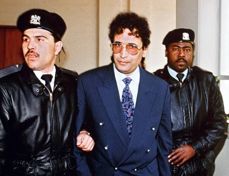 (FILES) A file picture taken on February 18, 1992 in Tripoli shows convicted Lockerbie bomber Abdelbaset Ali Mohmet al-Megrahi (C) being escorted by security officers. Abdelbaset Ali Mohmet al-Megrahi, who has prostate cancer, is to be freed from a British jail on compassionate grounds, British media reported on August 12, 2009. Megrahi is serving life with a minimum term of 27 years over the downing of Pan Am flight 103 over the Scottish village of Lockerbie, which killed 270 people in 1988. AFP PHOTO/MANOOCHER DEGHATI/FILES / AFP PHOTO / FILES / MANOOCHER DEGHATI