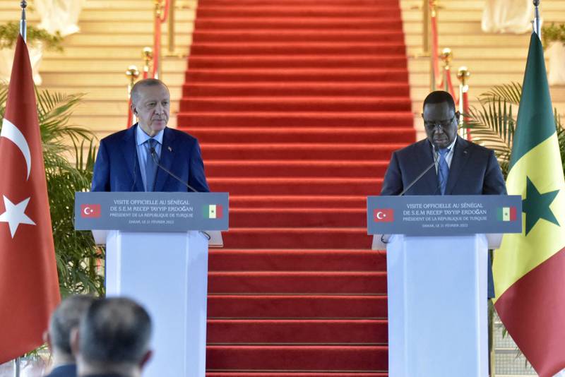 Mr Erdogan, left, holds a joint press conference with Mr Sall following their meeting at the Palais de la Republique in Dakar. AFP