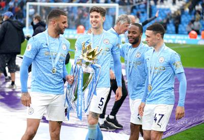 Left to right: Manchester City's Riyad Mahrez, John Stones, Raheem Sterling and Phil Foden with the Premier League trophy