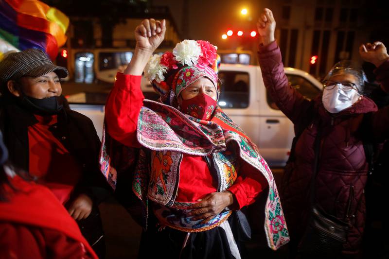 Supporters of leftist Pedro Castillo react outside the headquarters of the "Free Peru" party after Peru's electoral authority announced him as the winner of the presidential election, in Lima.