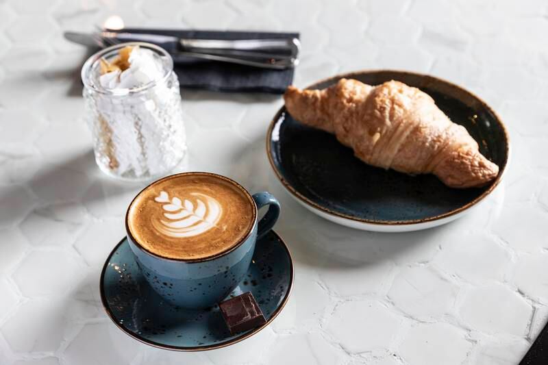 Snack options include croissants and a latte.