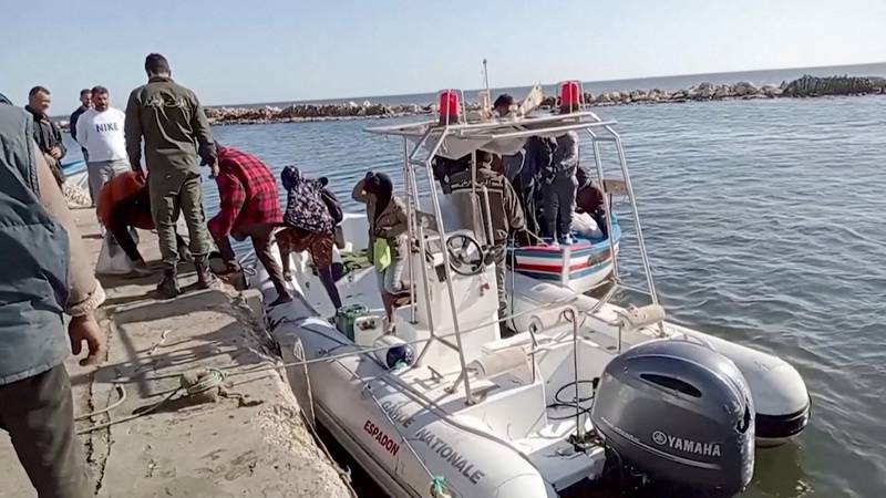 A Tunisian coastguard helps migrants get off a rescue boat in Safx, in April 2022. Reuters