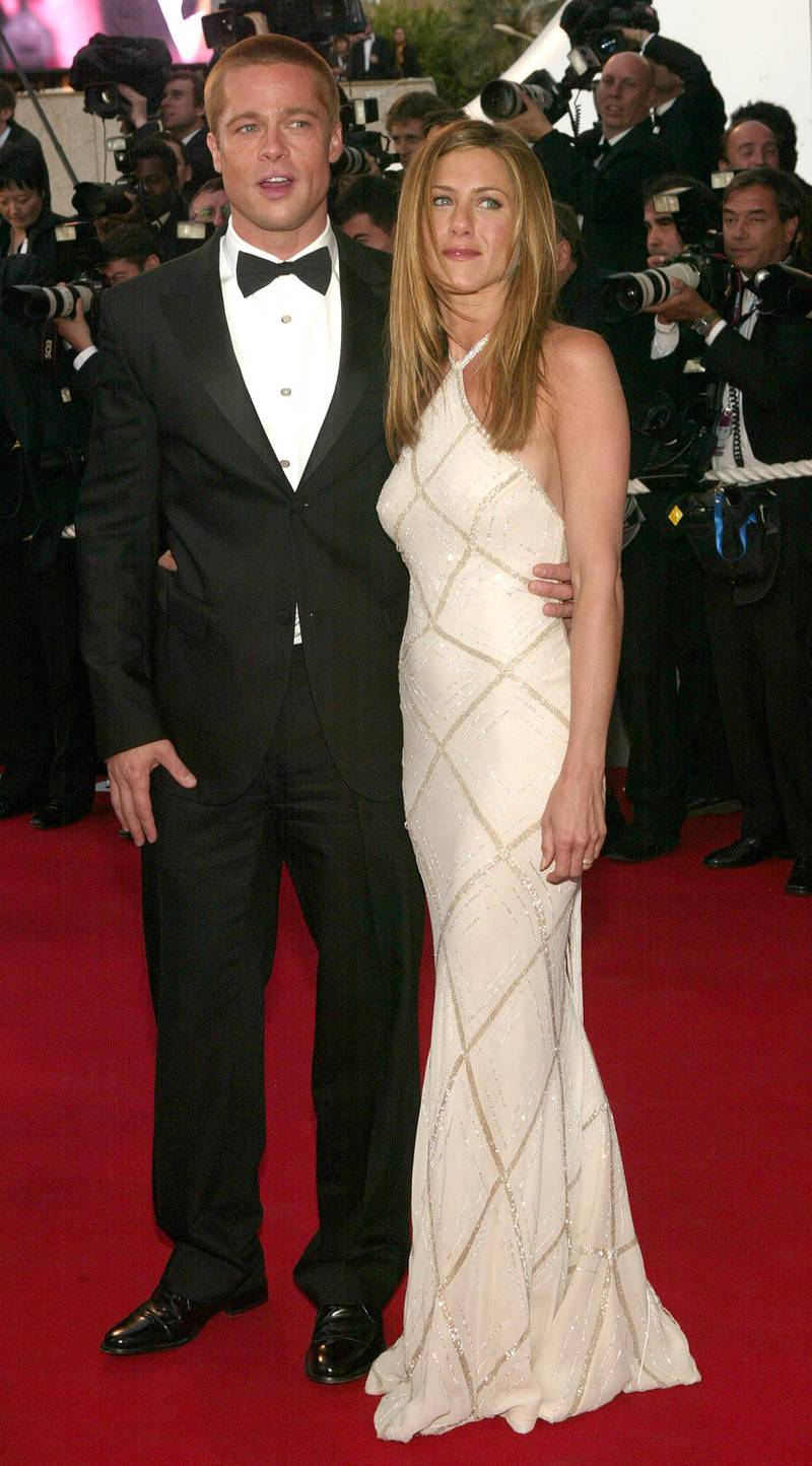 CANNES, FRANCE - MAY 13:  Actor Brad Pitt and wife actress Jennifer Aniston attend the World Premiere of the epic movie "Troy" at Le Palais de Festival on May 13, 2004 in Cannes, France. Aniston wears a dress by Versace. (Photo by Evan Agostini/Getty Images)

