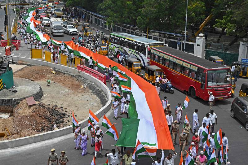 Members of the opposition Congress party carry a giant national flag during a procession marking Independence Day in Chennai, eastern India. AFP