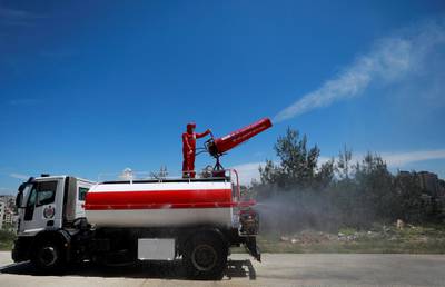 A member of Palestinian Civil Defence on a truck sprays disinfectants during a drill for dealing with coronavirus cases, amid concerns about the spread of the disease (COVID-19), in Ramallah in the Israeli-occupied West Bank April 23, 2020. REUTERS/Mohamad Torokman