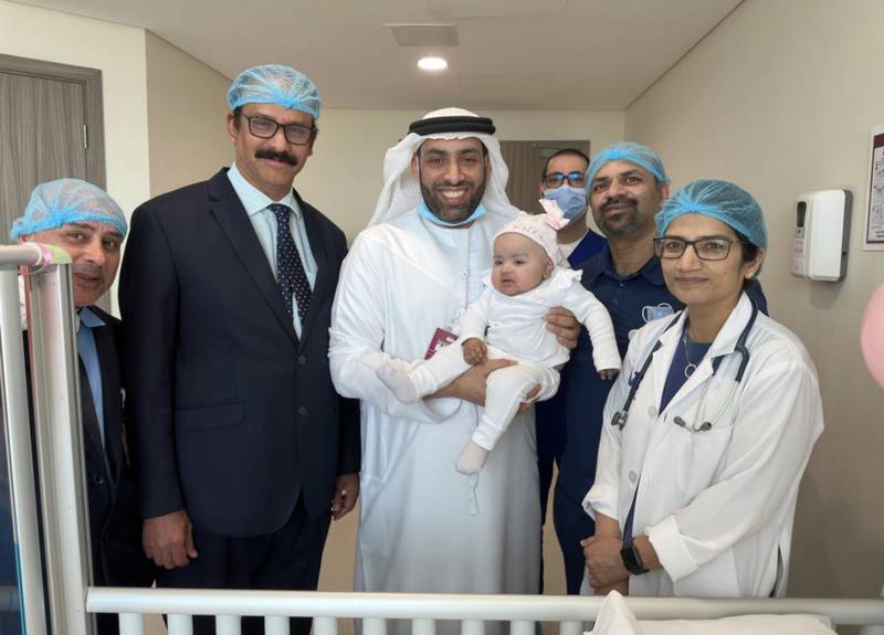 Baby Afeefa with her father and the team at Burjeel Medical City. Photo: Burjeel Medical City