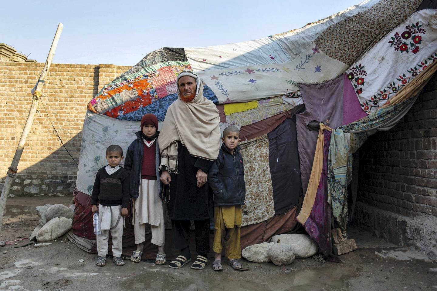 Tawas Khan and his children with their makeshift tent. Lynzy Billing for The National