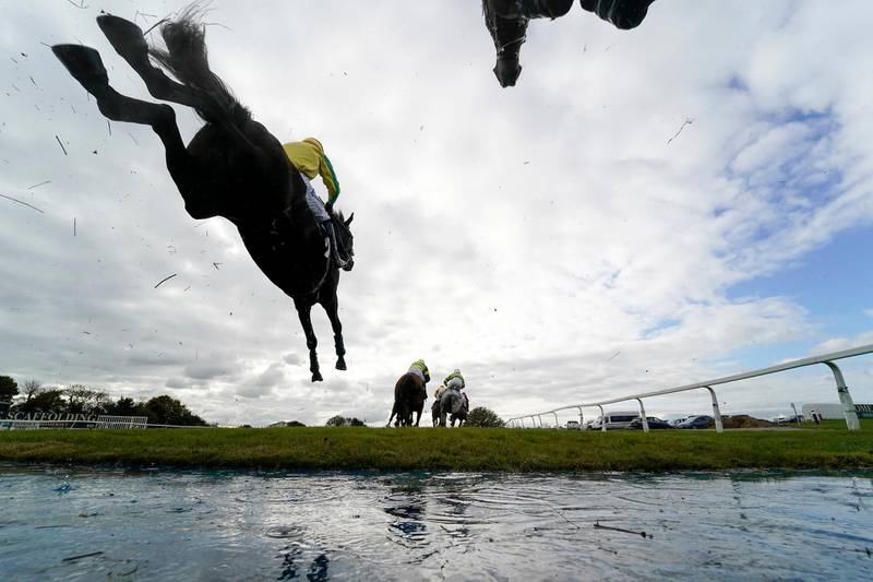 Runners and riders clear the water jump in The Use The racingtv.com Tracker Novices' Handicap Chase at Wincanton Racecourse on Wednesday, October 15. Getty