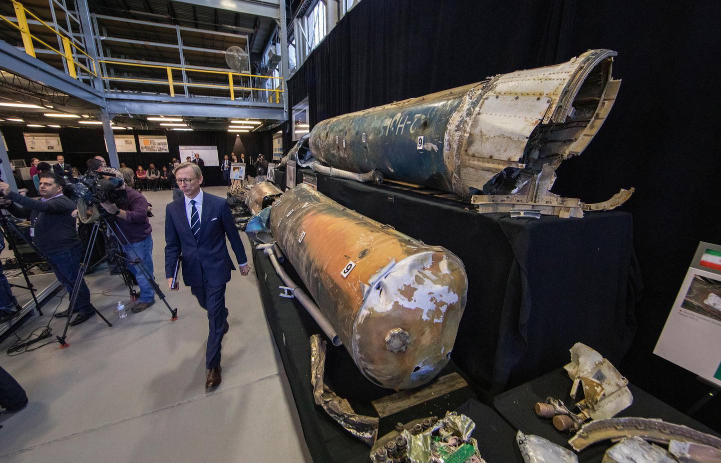 epa07197500 US Special Representative for Iran, Brian Hook (C), arrives for an 'Iranian Materiel Display' press conference in a hangar at Joint Base Anacostia-Bolling in Washington, DC, USA, 29 November 2018. Hook is walking past what are said to be recovered Iranian Qiam short range ballistic missiles.  EPA/ERIK S. LESSER