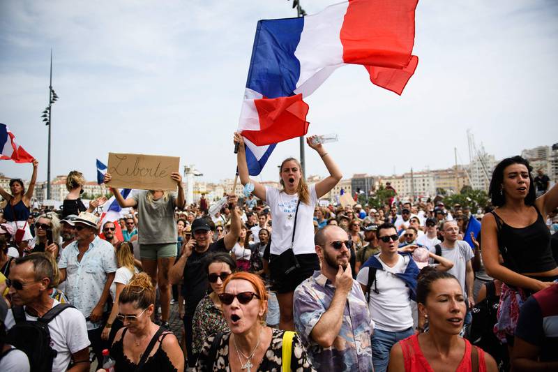 A protestor holds a placard reading ‘Freedom’ during a demonstration in Marseille against government calls for compulsory vaccination for some workers and the mandatory use of the health pass.