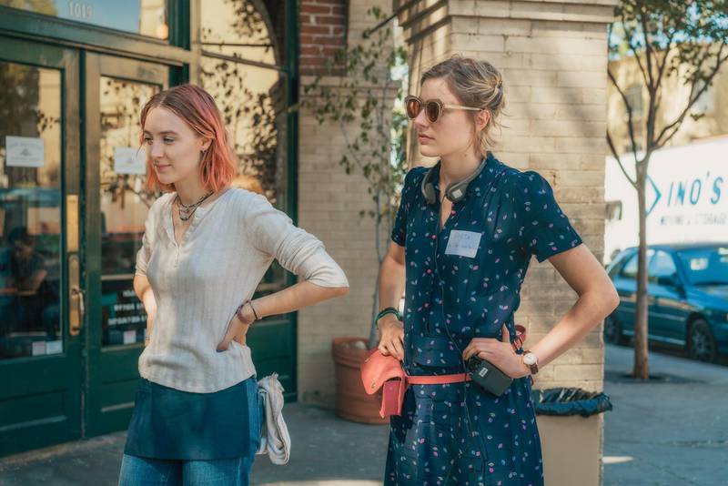This image released by A24 Films shows director Greta Gerwig, right, and Saoirse Ronan on the set of "Lady Bird." Gerwig is expected to be the fifth woman nominated for an Oscar for best director when the nominations for the 90th annual Academy Awards are announced on Tuesday.  (Merie Wallace/A24 via AP)