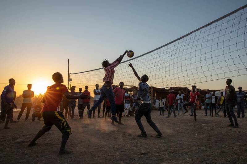 Refugees who fled the conflict in Ethiopia's Tigray region play volleyball at Um Rakuba refugee camp in Qadarif. AP