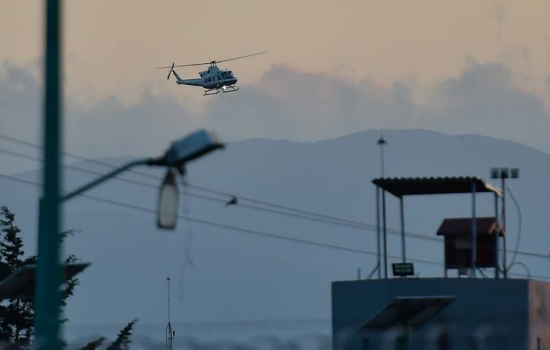 A helicopter, part of a security convoy used to transport Ovidio Guzman, arrives at the Altiplano prison in Toluca, Mexico. EPA