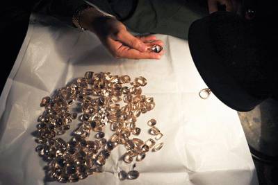 A craftsman checks gemstones at a workshop in Peshawar. Hasham Ahmed / AFP