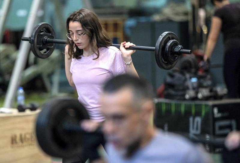 Ihsan Al Sakka does weight training and cardio excercises with his children, Huda, 15 and Nur, 20 at the Abu Dhabi Country Club on June 1st, 2021. Victor Besa / The National.Reporter: Haneen Dajani for News