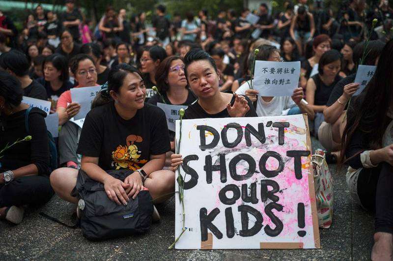 epa07647646 A group of Hong Kong mothers attend a rally in Hong Kong, China, 14 June 2019. The mothers started an online petition, signed by tens of thousands, to voice their disagreement with Chief Executive Carrie Lam's analogy likening herself and protesters of the extradition bill to a mother and her spoiled children during an interview this week. The petition said the mothers would definitely not use tear gas, rubber bullets and bag bean rounds on their own children. It also urges Lam, 'as the head of the city and a servant to the people', to postpone or scrap the legal amendments in light of the strong opposition.  EPA/JEROME FAVRE