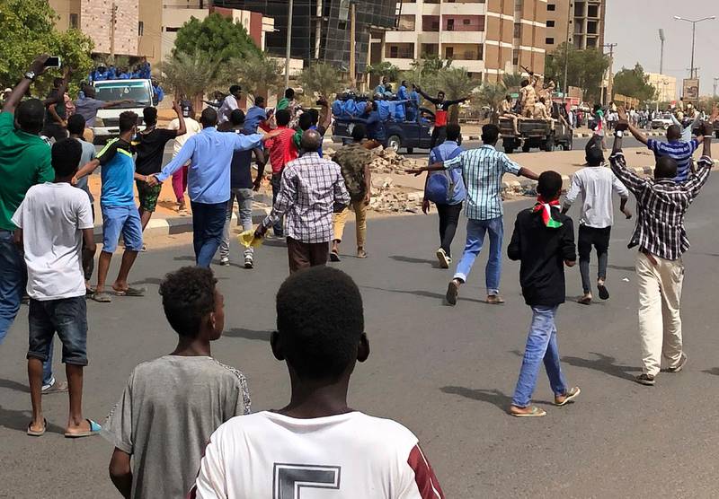 Sudanese protesters shout slogans as they block the road in front of riot police and an army convoy, during a demonstration against the military council, in Khartoum, Sudan, on Sunday, June 30, 2019. AP Photo