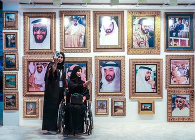 Abu Dhabi, U.A.E., February 20, 2019. INTERNATIONAL DEFENCE EXHIBITION AND CONFERENCE  2019 (IDEX) Day 4--  Colour images.-- Visitors at the show do some selfies at the Sheiks of the UAE Photography Wall. Victor Besa/The NationalSection:  NA
