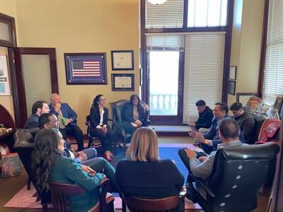 Ms Bayat, centre, participates in a meeting in the US. Photo: Crystal Bayat