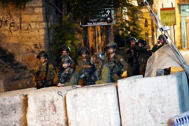 Israeli troops clash with Palestinian protesters in the city centre of Hebron in the West Bank. EPA