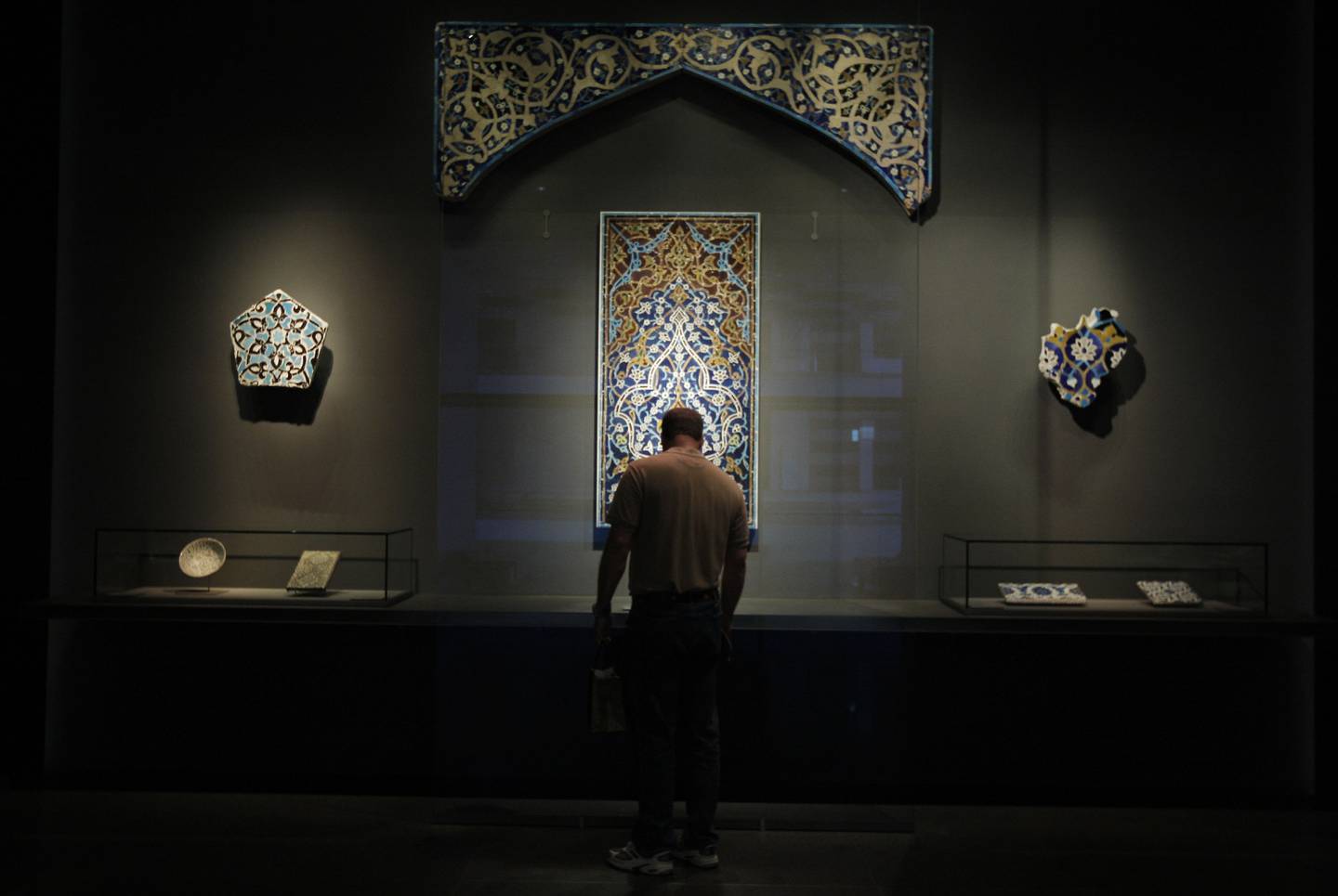 DOHA, QATAR - February 18, 2009: A man looks at mosaic tile artifacts from Turkey, Iran, and central Asia from 13th-15th centuries at the Museum of Islamic Art on the corniche of Doha, Qatar  (Ryan Carter / The National)

*** For Travel story by Mo Gannon 
 *** Local Caption ***  RC058-TravelDoha.jpgRC058-TravelDoha.jpg