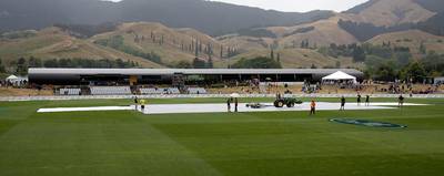 The covers lay on the field as the rain falls during the second one-day international cricket match between New Zealand and Pakistan at Saxton Oval in Nelson on January 9, 2018. (Photo by Marty MELVILLE / AFP)