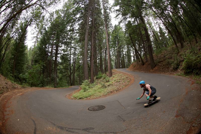 Marcus Giovannone rides his skateboard down a hill near Mount Shasta, California. Getty Images / AFP
