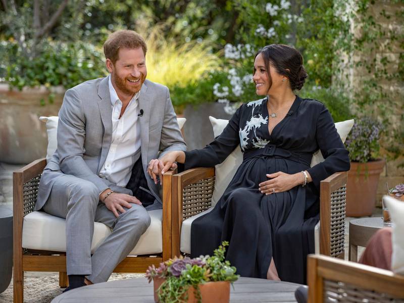 This image provided by Harpo Productions shows Prince Harry, left, and Meghan, Duchess of Sussex, speaking about expecting their second child during an interview with Oprah Winfrey. "Oprah with Meghan and Harry: A CBS Primetime Special" airs March 7 as a two-hour exclusive primetime special on the CBS Television Network. (Joe Pugliese/Harpo Productions via AP)