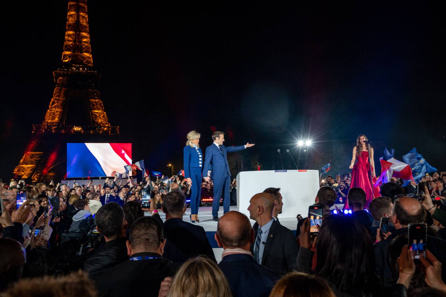 Victorious French President Emmanuel Macron and his wife Brigitte listen to Egyptian mezzosoprano Farrah El Dibany singing ‘La Marseillaise’ near the Eiffel Tower in Paris on Sunday. Reuters
