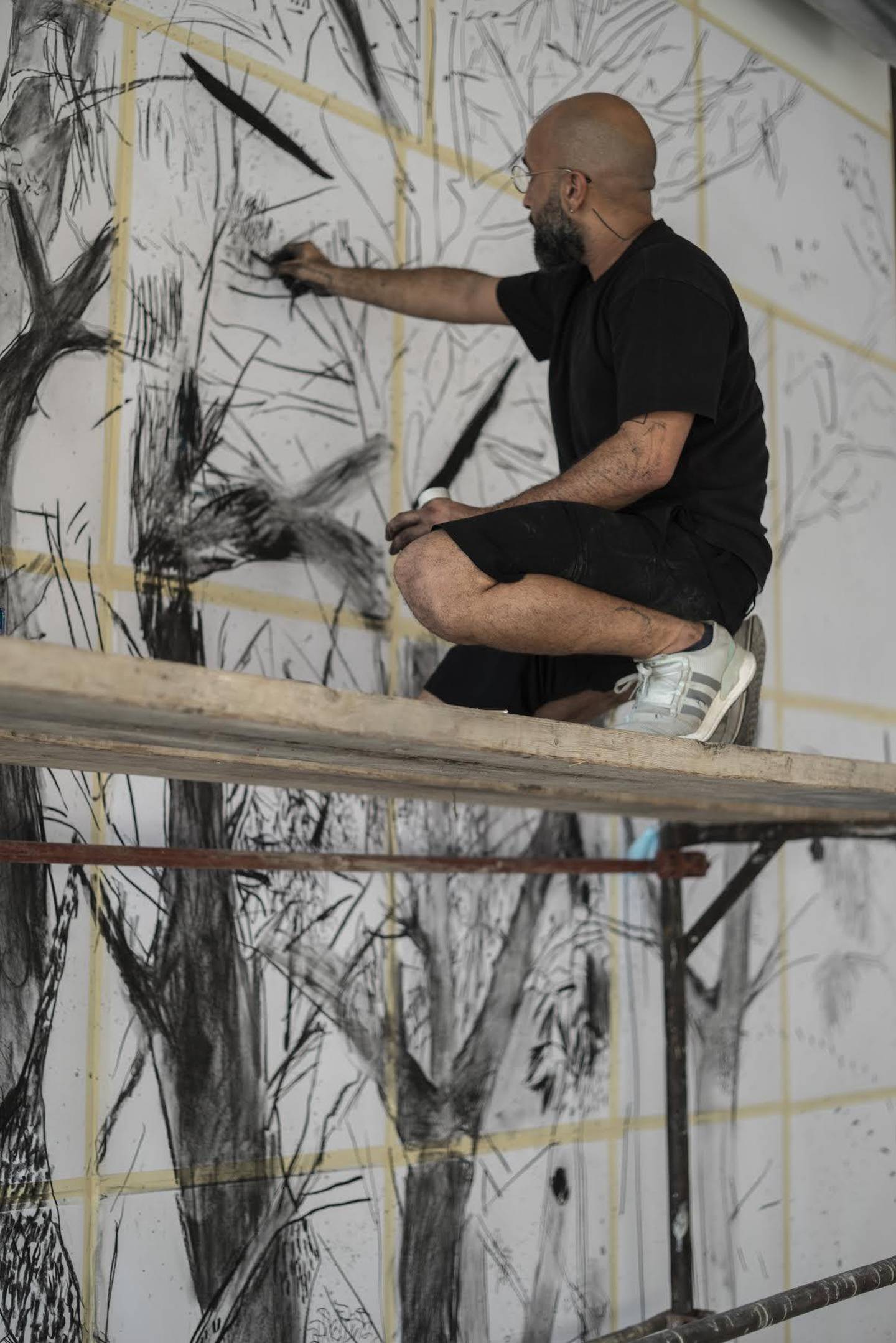 Lebanese artist Abed Al Kadiri working on his mural. Elias Daaboul