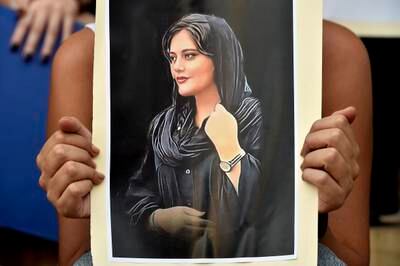 An activist holds a poster depicting Mahsa Amini during a protest outside the Lebanese National Museum in Beirut. EPA