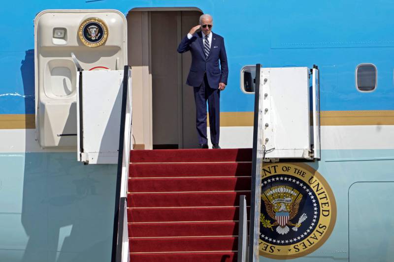 Mr Biden waves before boarding Air Force One as he leaves Israel's Ben Gurion Airport on July 15. AFP
