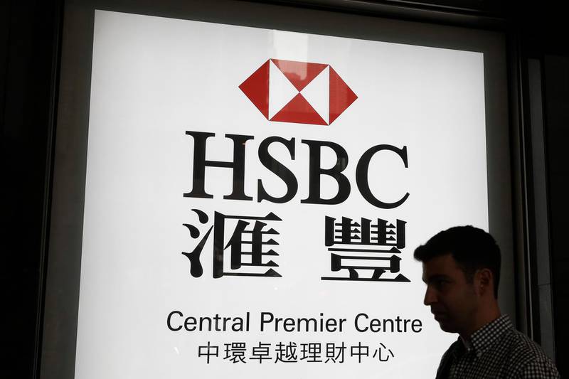 FILE - In this May 4, 2018, file photo, a man walks past a branch of HSBC bank in Hong Kong. Europe's biggest bank has reported that its net profit fell 53% in 2019 to $6 billion. London-based HSBC, whose profit is mainly from Asia, said it plans to revamp its U.S. and European business and shed $100 billion in assets to improve its profitability.  (AP Photo/Kin Cheung, File)