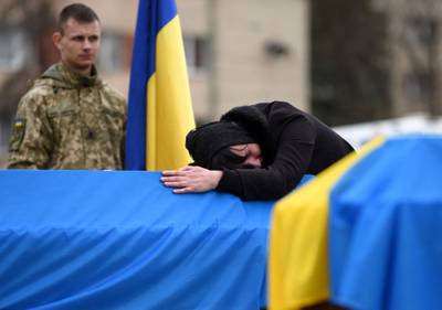 The mother of Ukrainian soldier Lubomyr Hudzeliak, who was killed during Russia's invasion of Ukraine, mourns during his funeral in the western Ukrainian city of Lviv. AFP