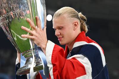 Manchester City's Norwegian striker #9 Erling Haaland poses with the European Cup trophy as they celebrate winning the UEFA Champions League final. AFP