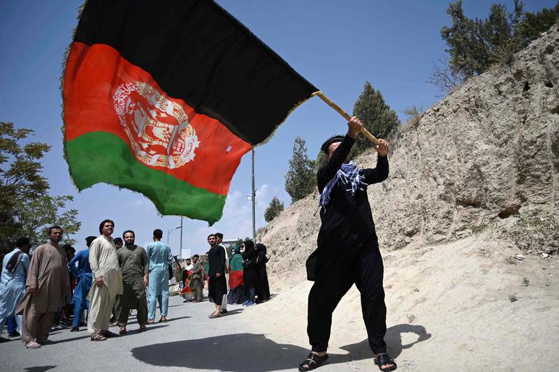 A man waves Afghanistan's national flag in Kabul, as the country marks its 102nd Independence Day on Thursday, August 20. This commemorates the country regaining full independence from British influence in 1919. AFP